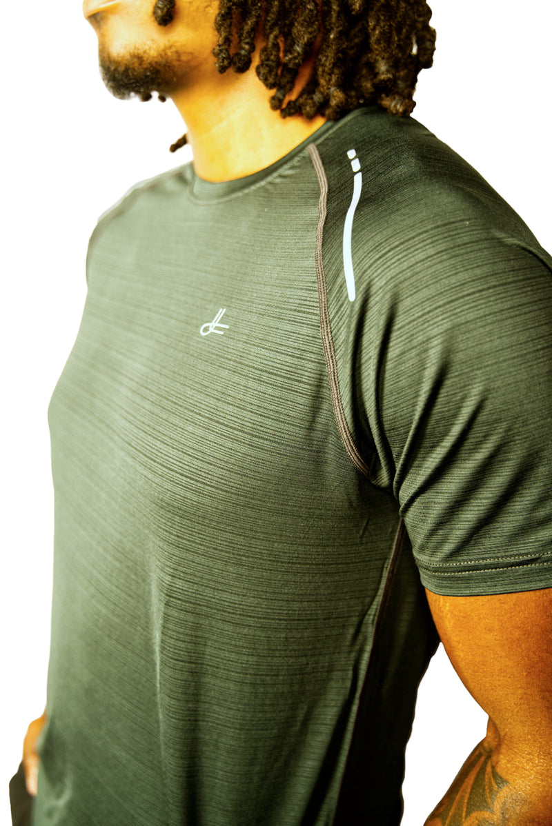 Man wearing a forrest green athletic shirt with  Kamili logo